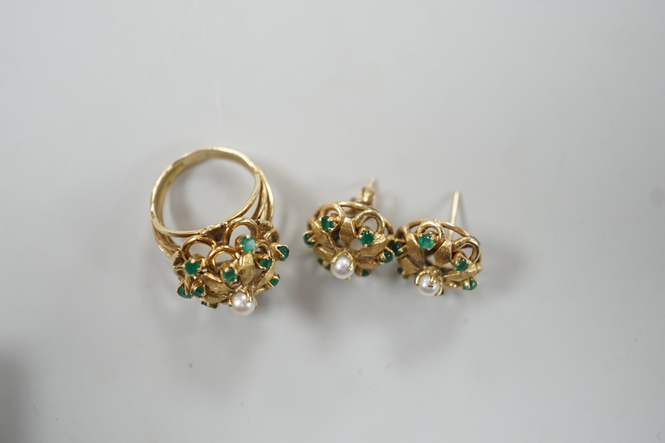 A modern continental, cultured pearl and green stone cluster set dress ring, size N, and a pair of matching earrings, one butterfly missing, gross weight 15 grams.